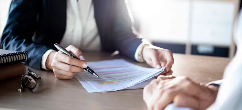 Signing an agreement at a desk
