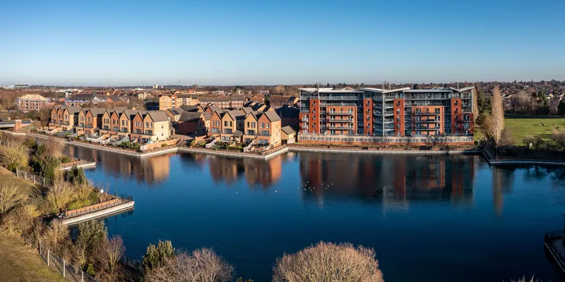 Waterside apartments reflected in a lake